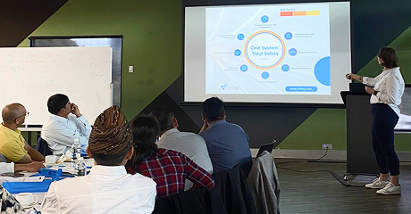Leadership team reviewing iottag portfolio dashboards during a boardroom presentation