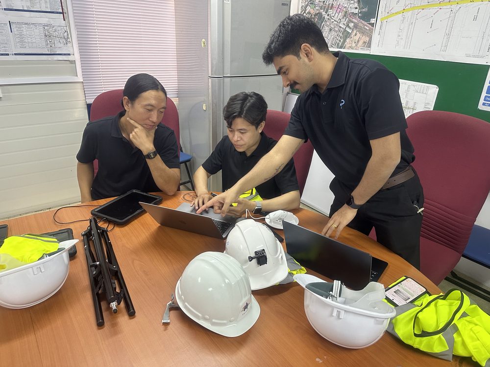 iottag specialists reviewing tag hardware and laptops around a desk