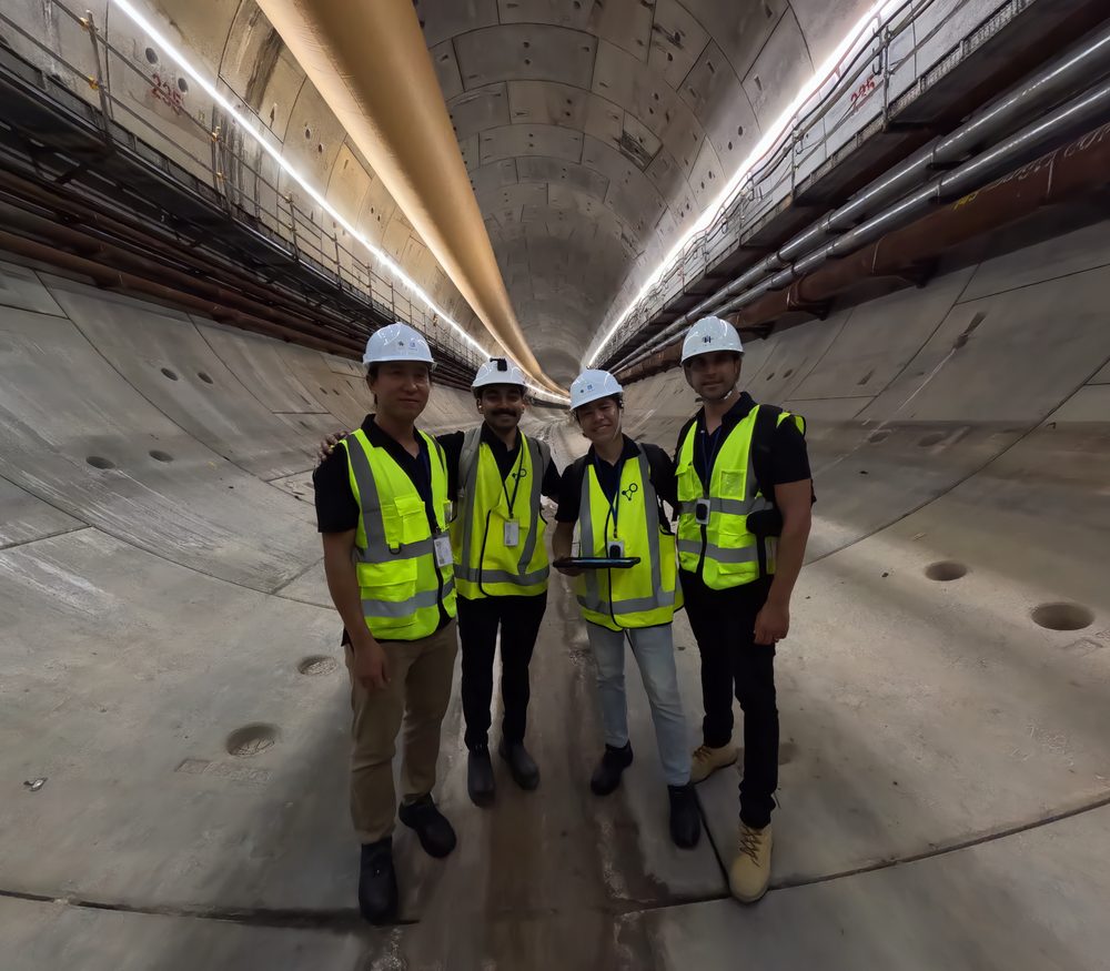 Four iottag engineers in hi-vis vests and hard hats inside a tunnel