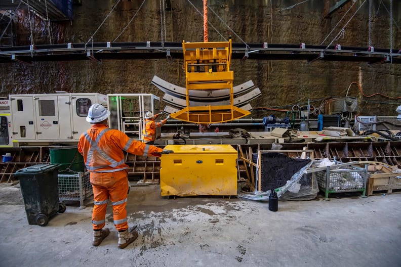 Worker beside yellow maintenance machinery