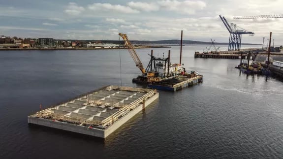 Crane barge and flat-top barge operating on the water