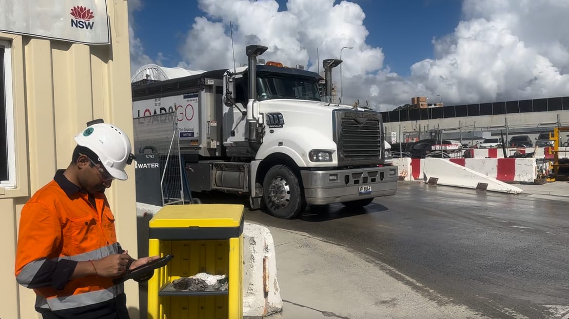 Truck moving through an active work area