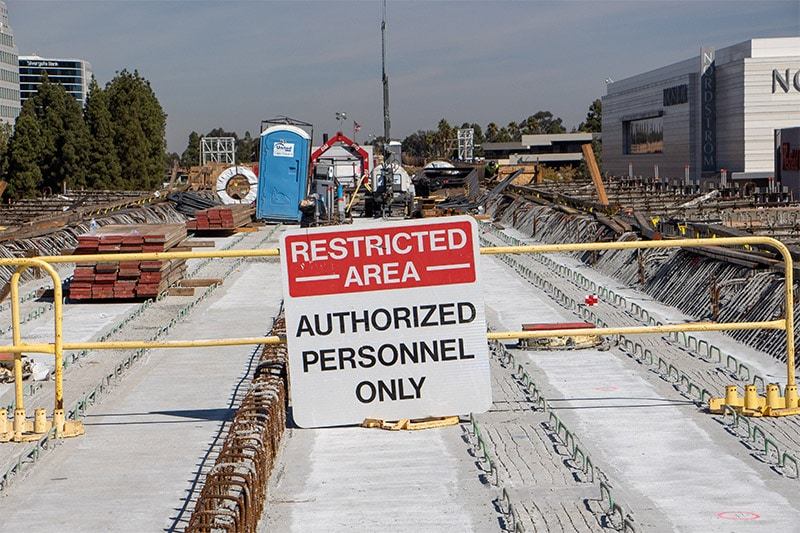 Restricted area sign reading Authorized Personnel Only on a barrier across a construction deck