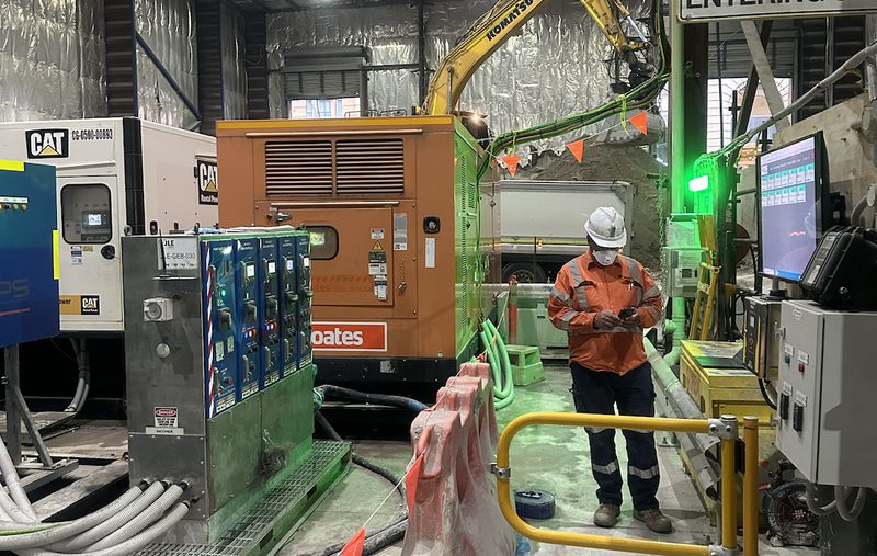 Operator monitoring site equipment beside a control screen