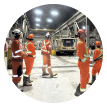 Operations crew meeting inside a plant workshop
