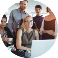 Executive team collaborating around a laptop