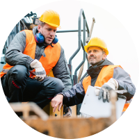 Site team in orange workwear inspecting equipment together