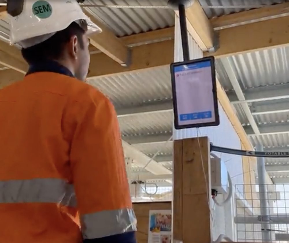 Worker tagging on at a site access control point before entering an operational area