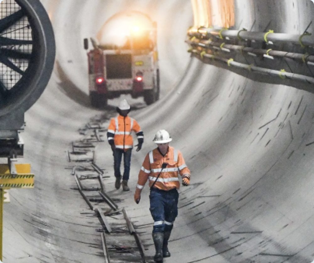 Workers walking through a tunnel under construction