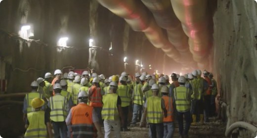 Workers gathered for a pre-shift briefing inside a tunnel