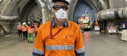 Site supervisor wearing a respirator mask at an underground works area