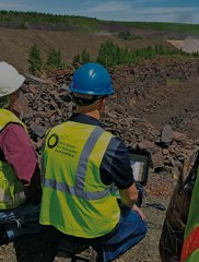 Workers surveying conditions across an open site