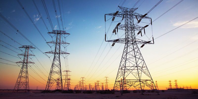 High-voltage transmission towers at sunset