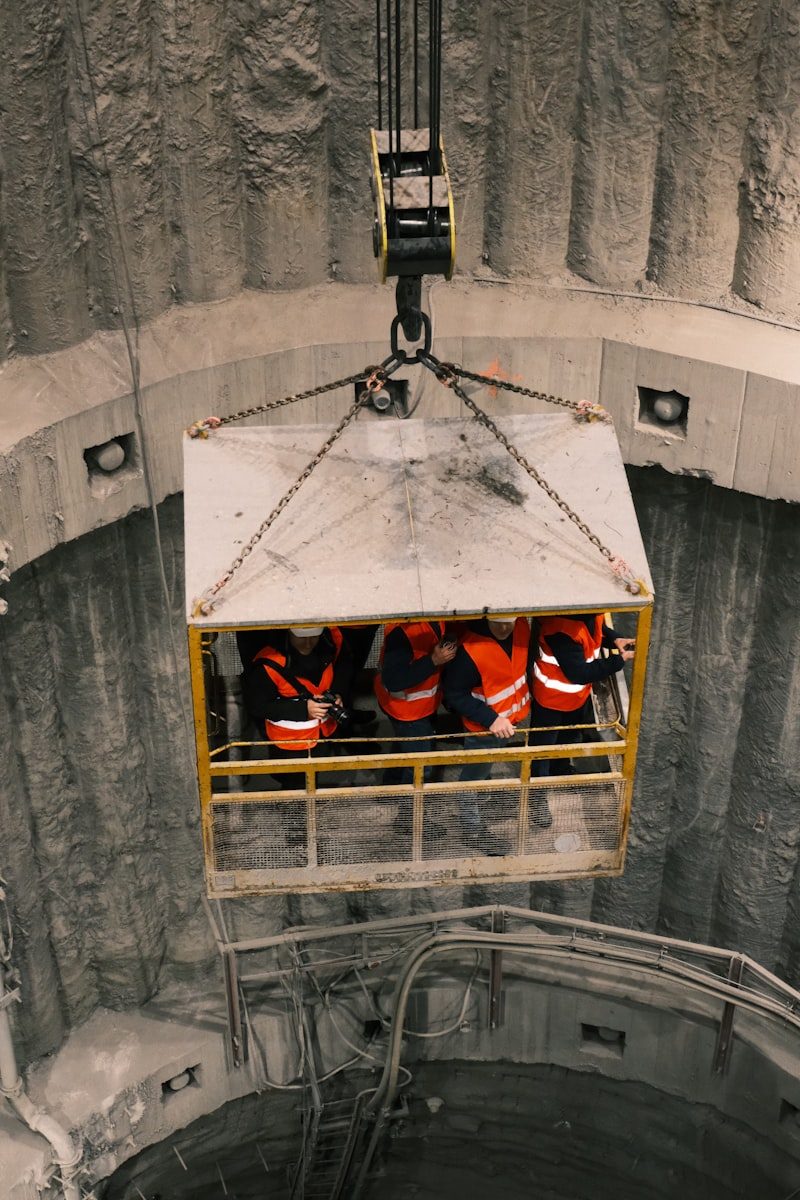 Crew riding a shaft cage to their work area