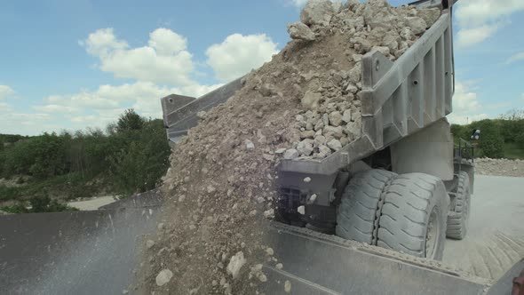 Haul truck dumping fragmented rock at the crusher